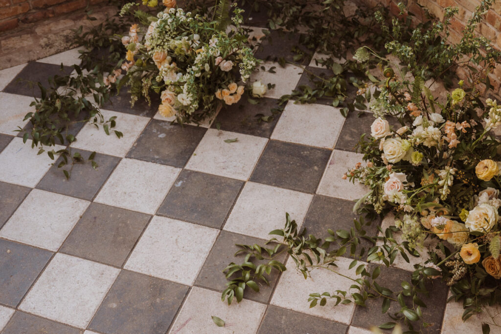 a black and white tile floor decorated with spring florals